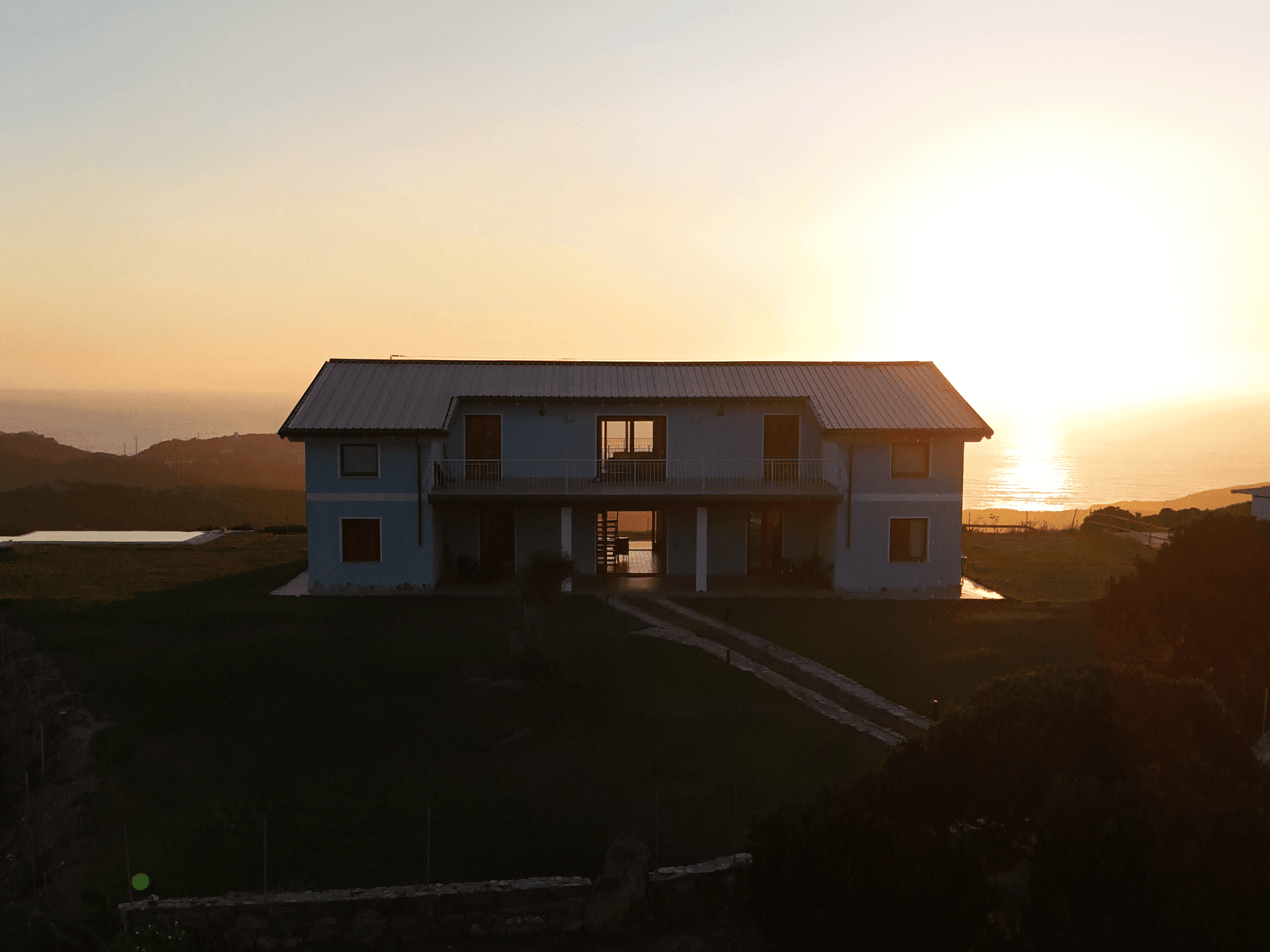 Seaside villa at sunset with panoramic views of the hills and coastline